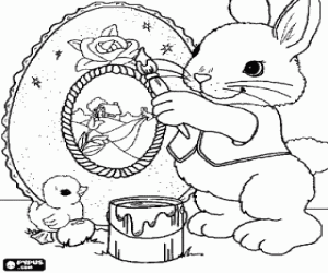 Coloriage Lapin en peignant un oeuf de Pâques