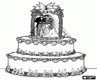 Le impressionnante gâteau de mariage décorées avec des figurines de la mariée et le marié